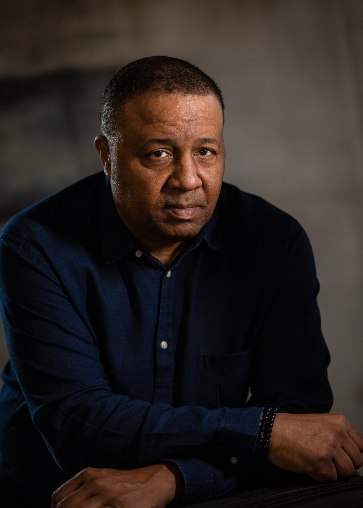 A man in a black shirt is sitting down